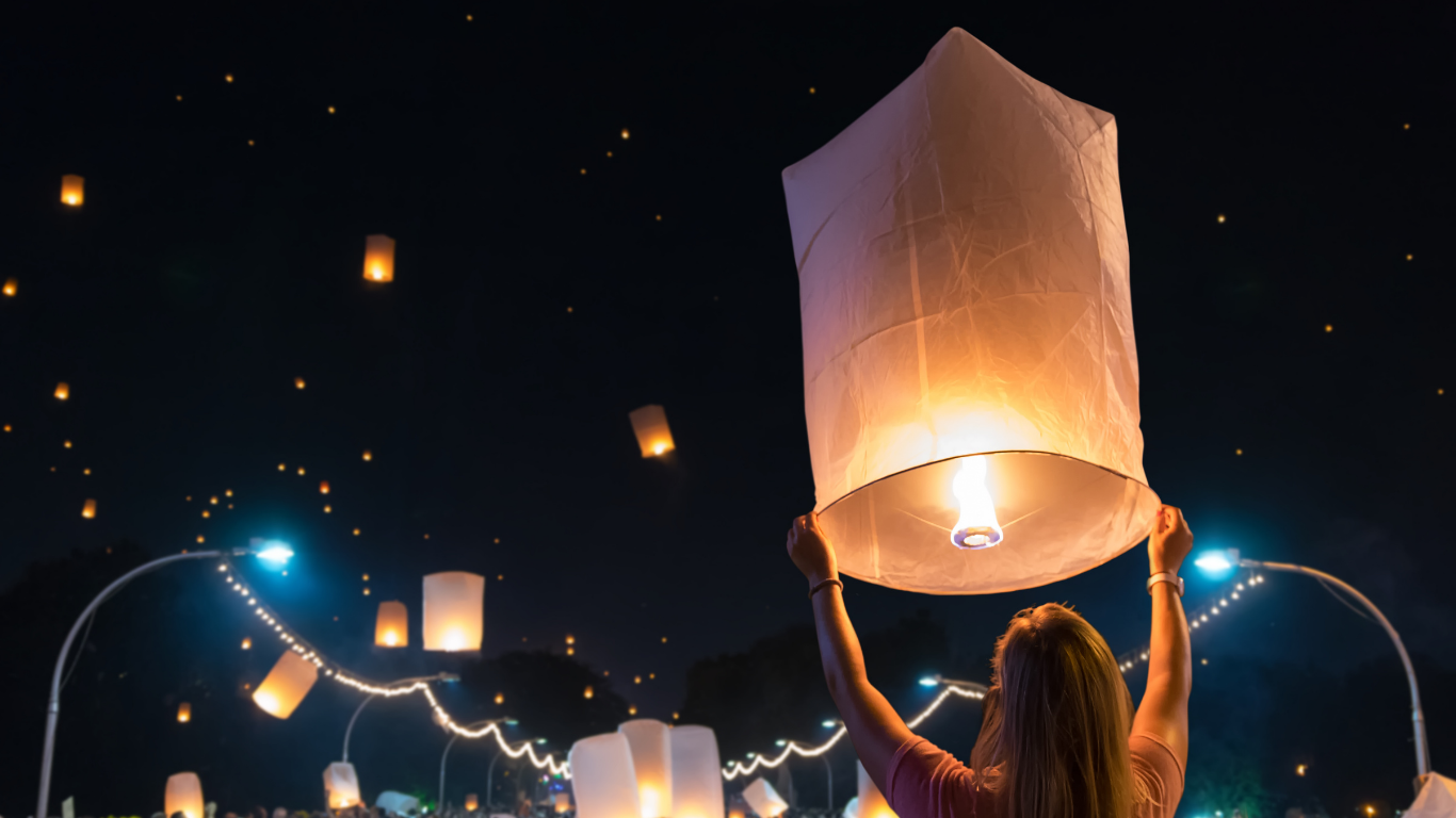 Visitor releasing a sky lantern at Yi Peng